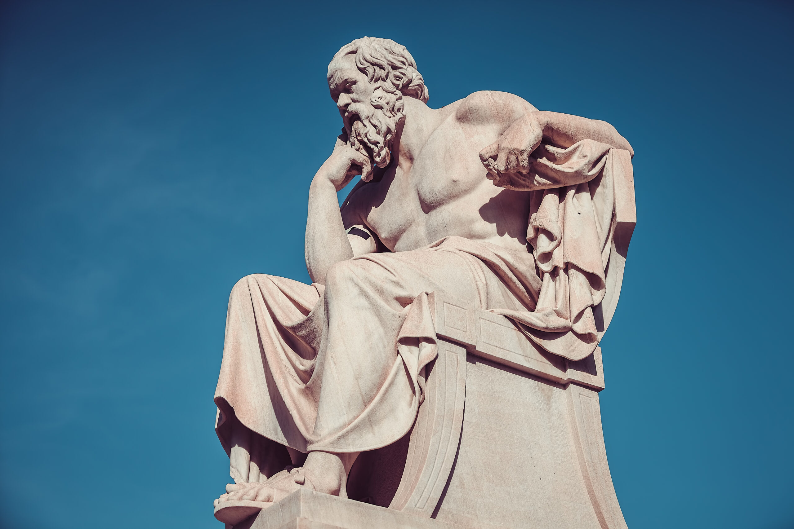 A statue of Socrates deep in thought—capturing the timeless wisdom of questioning as a path to greater understanding.