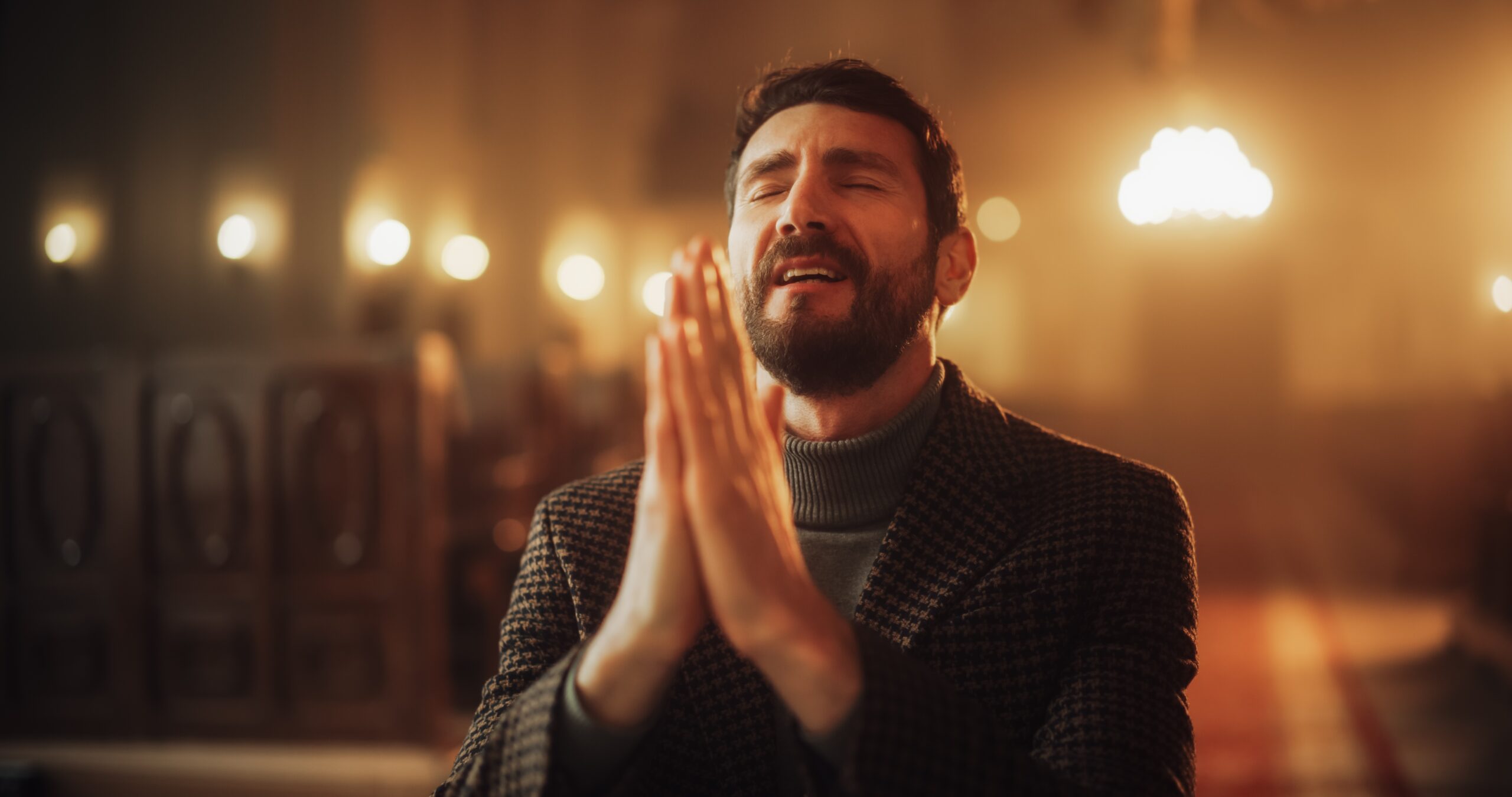 A man in deep prayer inside a softly lit church—reflecting on timeless biblical wisdom that speaks to both believers and seekers alike.